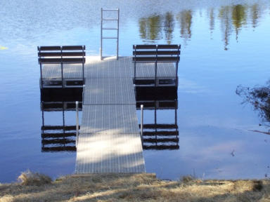 floating dock with two benches and a swimming ladder